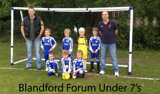 The Blandford Forum Under 7's football team with two of the MVS team